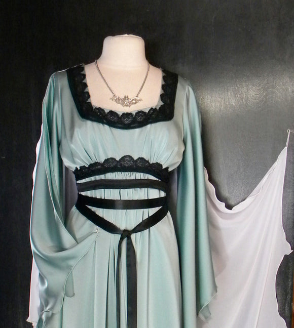 Lily Munster Muted Green Dress With Bat Necklace